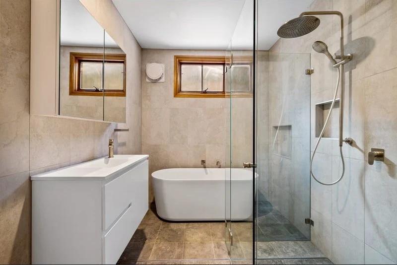 Freestanding bath and frameless glass shower installed during a full bathroom rebuild in South East Queensland